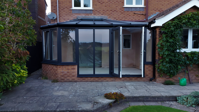 A Square Victorian style conservatory with French doors in Anthracite Grey